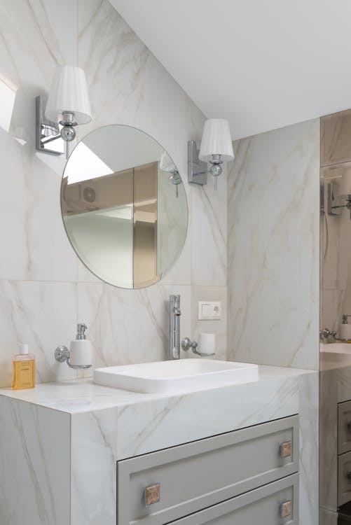 Custom tempered glass shelf with polished edge installed in bathroom by High West Glass
